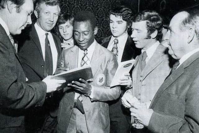 Pele, alongside Derek Dooley and The Star's Tony Pritchett, signs autographs at an event afterwards