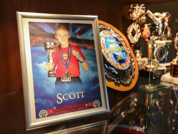 Scott Marsden with some of his kickboxing trophies (SWNS)