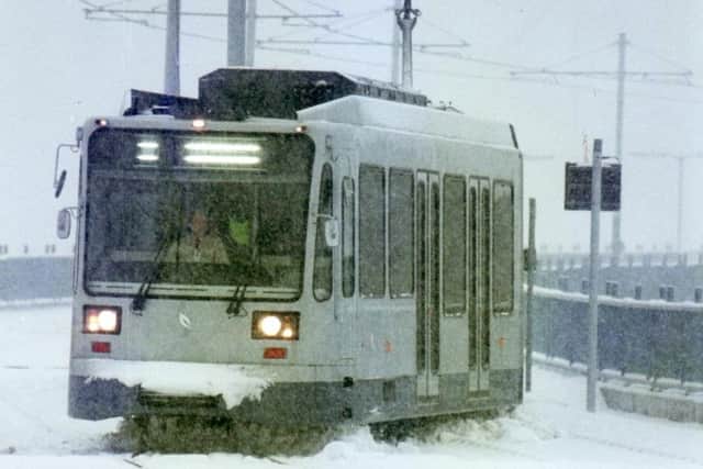 A tram trundles through the snow ahead of the service's full launch.