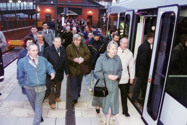 The first passengers race for the tram at Meadowhall in 1994.