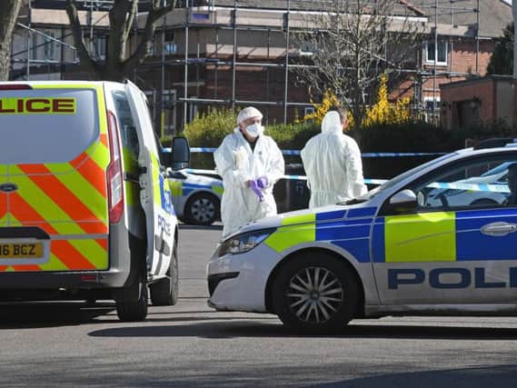 Forensic officers at the scene of the fatal stabbing