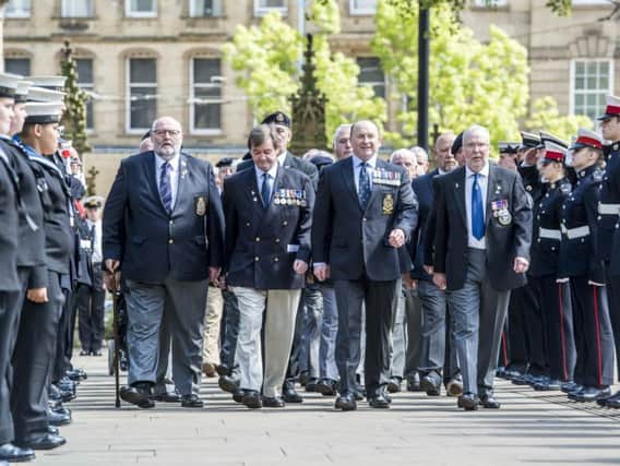 Survivors from HMS Sheffield make their way through a guard of honour into the Service at Sheffield Cathedral
