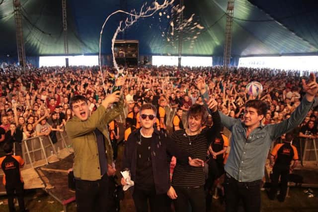 The Sherlocks pop champagne to celebrate debut album Live For The Moment charting at number six while on stage at Leeds Festival. Photo: Glenn Ashley.