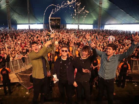The Sherlocks pop champagne to celebrate debut album Live For The Moment charting at number six while on stage at Leeds Festival. Photo: Glenn Ashley.
