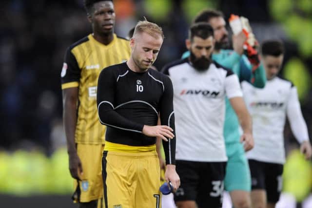 Barry Bannan leaves the pitch dejected after defeat to Derby County