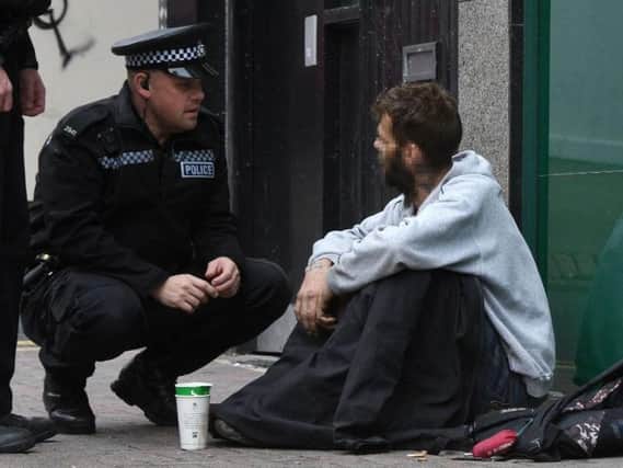 A police officer talking to a beggar in Sheffield city centre