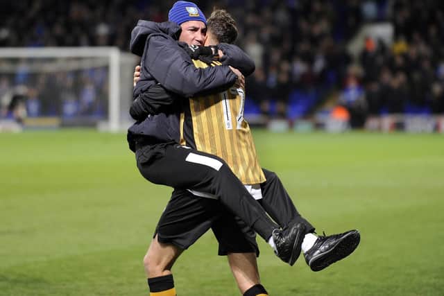 Wednesday's coaching staff give Nuhiu an embrace after his late equaliser
