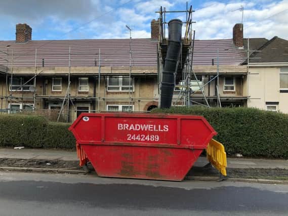 Skips have been left on the grass verge.