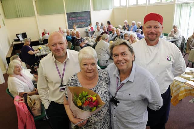 Volunteer Marcia Bramhall is presented with a bouquet by members of South Yorkshire Community Rehabilitation Company