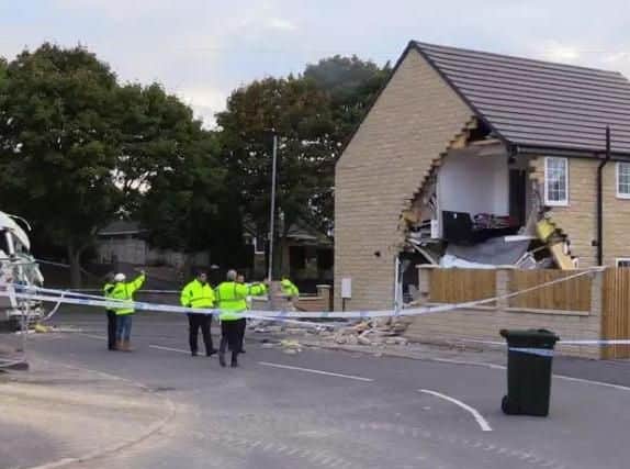 A woman died and a house was damaged in collisions involving a stolen lorry