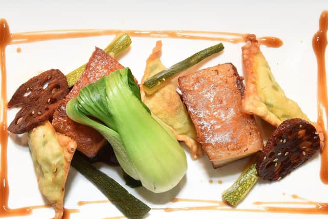 Slow roasted pork belly, with braised lotus root, Korean BBQ sauce, pork samosa, and Wortley Arms allotment courgette kimchi at The Wortley Arms.