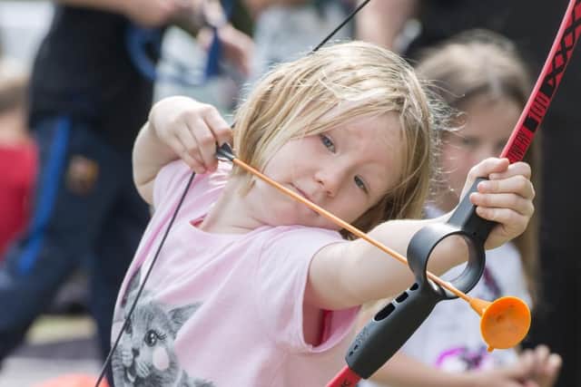 A youngster takes aim during one of the summer sports sessions