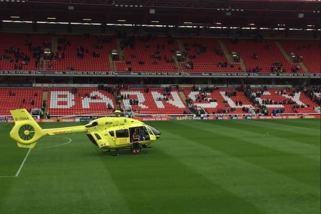 The air ambulance lands at Barnsley FC's Oakwell Stadium after a man collapsed beside the pitch (pic: Scott Merrylees)