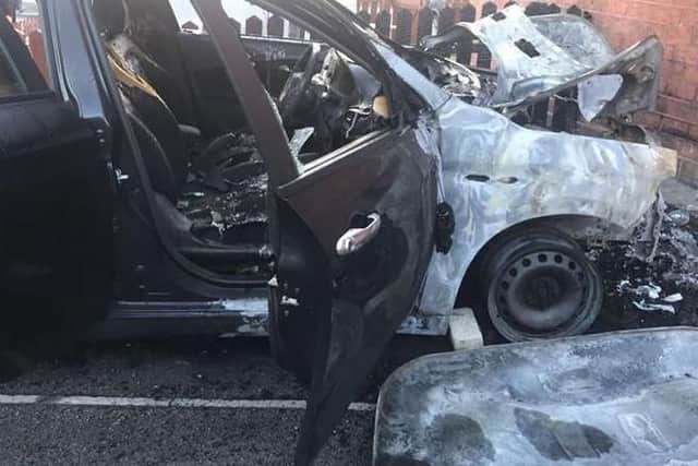 The wreckage of a car set alight in an arson attack in Sheffield last night