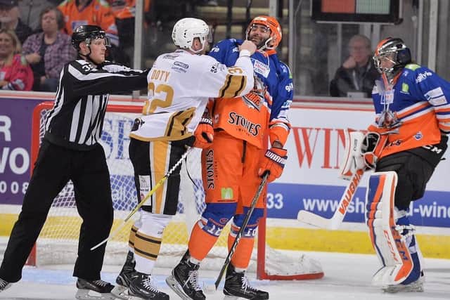 Chris Lawrence laughs off a punch in the face from Jacob Doty during Saturday's 3-2 win over Nottingham Panthers. Pic by Dean Woolley