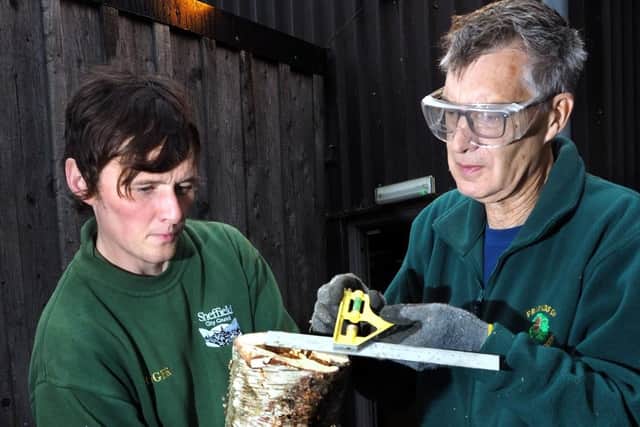 Conservation work in Ecclesall Woods to help willow tits: Phil May (right) and Matt Coster measuring the cavity of a nesting log being made for willow tits by David Bocking