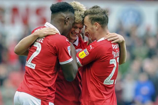 Cameron McGeehan celebrates his goal with Dimitri Cavare and Mike Bahre. Picture Scott Merrylees