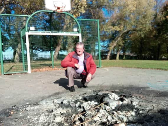 Firebugs: Coun Charlie Wraith surveys damage from the latest arson attack in Cudworth Park.
