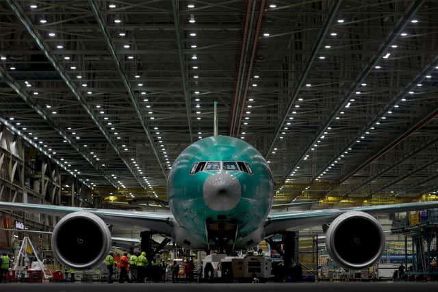 A  Boeing 777 aircraft rolls out of the factory in Everett, Wash.