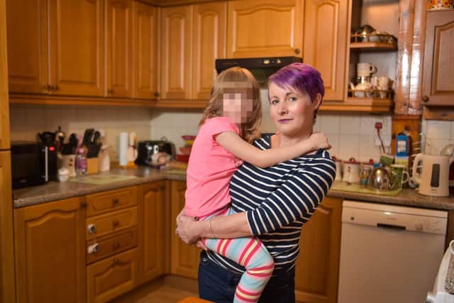 Jodie Keegans, 36, with her daughter whose comments at school sparked the investigation - Credit: SWNS