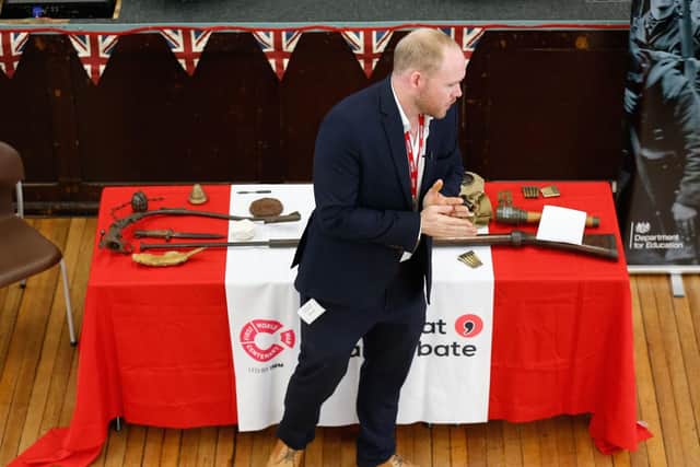 Military Historian, Dan Hill showing students artefacts, artillery and uniforms used during the war by soldiers not much older than many of the students taking part in the debate (Picture: CPG photography)
