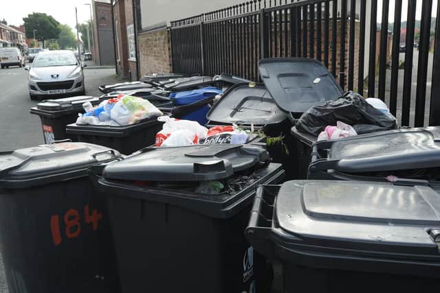 Overfilled black bins waiting for collection