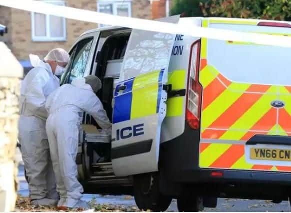 Scenes of crime officers at the scene of a fatal flat fire in Sheffield yesterday