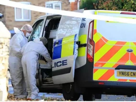 Scenes of crime officers at the scene of a fatal flat fire in Sheffield yesterday