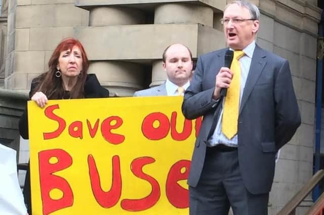Councillor Ian Auckland with fellow Liberal Democrat councillors with a 'save our buses' placard
