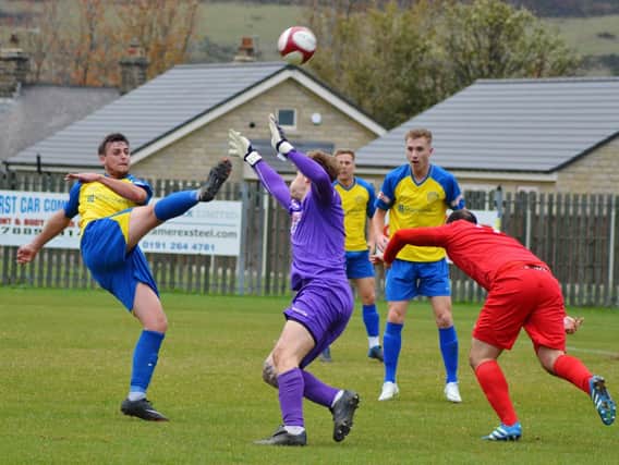 Scott Ruthven hooks a shot over the Wisbech keeper only to see it cleared off  the line. Picture: Gillian Handisides