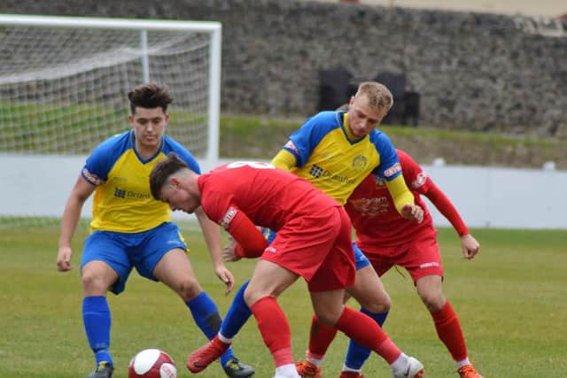 Tom Charlesworth (left) and Brodie Litchfield try to find a way past the Wisbech Town defence. Picture: Gillian Handisides