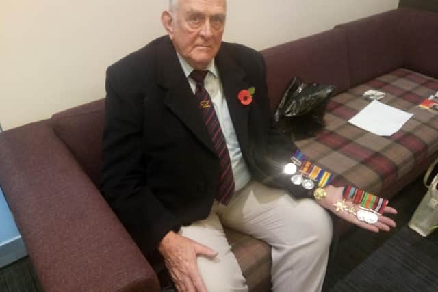 Tony Bown with the military medals he, his father and his grandfather were awarded