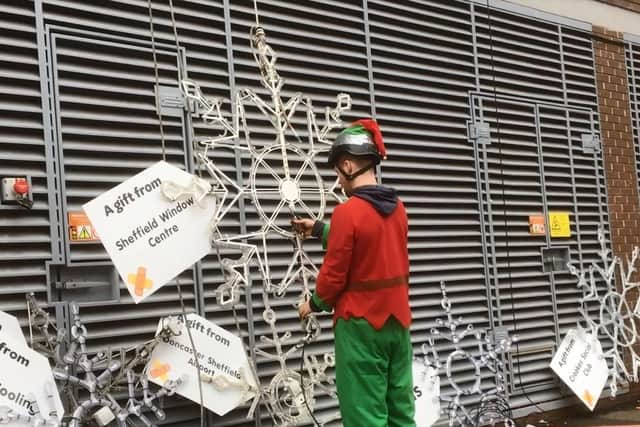 One of Santa's Elves helped to put up the snowflakes