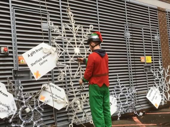 One of Santa's Elves helped to put up the snowflakes