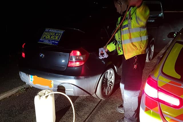 A car - which had been seized after a diesel tank was found in the boot - being dipped for red diesel