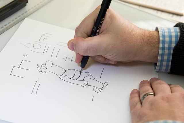 Star cartoonist James Whitworth working on his latest piece.