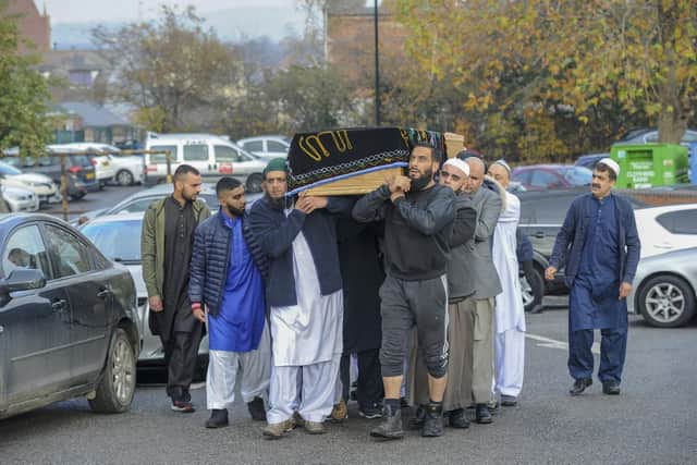The coffin is brought into the mosque. Picture Scott Merrylees