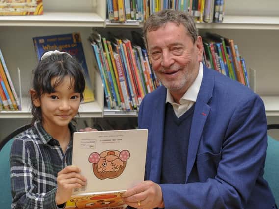 Lord Blunkett is read some Japanese by Umi Sarkar at the launch of the new multilingual children's library in Sheffield. Picture Scott Merrylees