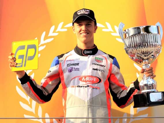 Ben Barnicoat clutching his Senior X30 GP trophy and the GP number plate.