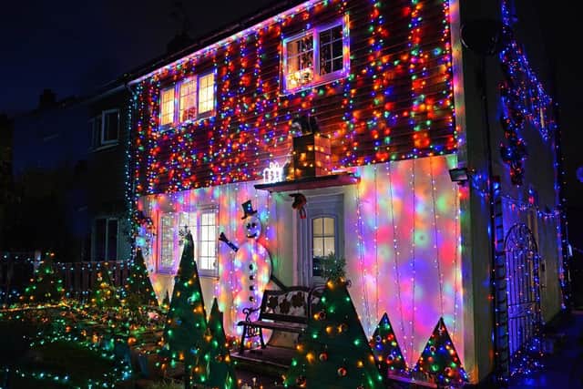John Berry's home, includes around 8,000 lights, handmade Christmas Trees and a seven and half foot Snowman.