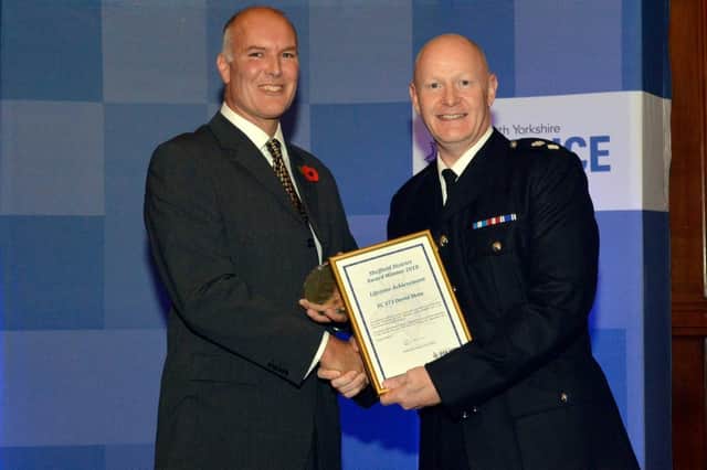 PC David Shaw receives his award from Chief Supt Stuart Barton. Picture: David Massey/Sheffield Central NHP.