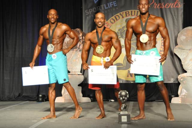 Ashley on stage with the top three men at the Global Bodybuilding Competition earlier this month