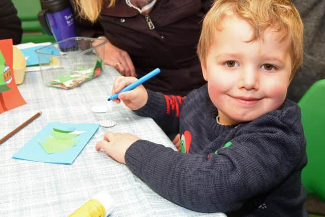 George Stacey makes a Christmas card at the Whirlow Hall Farm Christmas Fayre