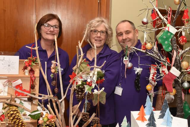 Carole Clarke, Maggie Macdougall and Barrie Grubb, of the Stroke Association Sheffield, with their Christmas decorations at the Tapton Hall Craft Fayre