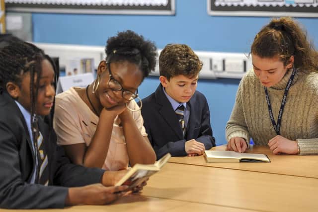 A paired reading scheme with sixth form students and younger pupils.  Picture Scott Merrylees