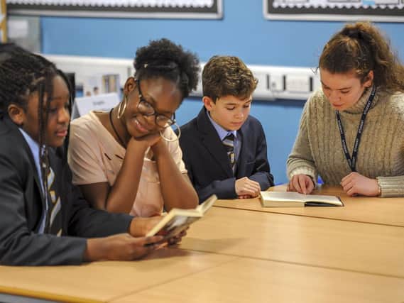 A paired reading scheme with sixth form students and younger pupils.  Picture Scott Merrylees