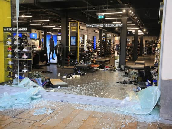 Smashed windows at JD Sports on The Moor.