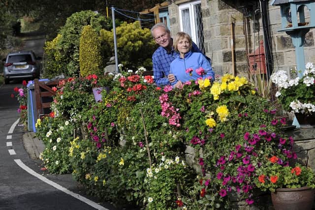 Pictured are Sally and Brian Williams outside their cottege on Hollin House Lane,Loxley Valley,who are in dispute with Sheffield City Council over their flower beds after a neighbour complained........Pic Steve Ellis