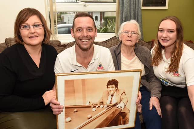 Steve Harrison with his family, and a photo of his father who inspired him to start the snooker club