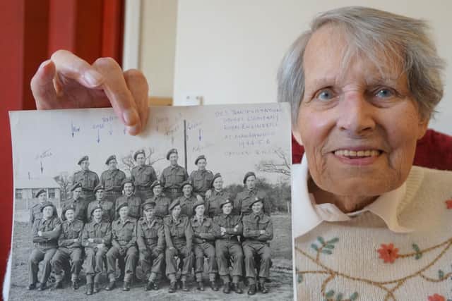 Louise Jennings with a photo of herself as a young sergeant named Robert
